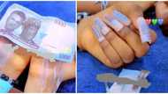 Just like Nancy Isime, lady goes viral for using N1k naira note to design her artificial nails