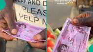 Man shows off fake N200 note someone gave him in Lagos market, video sparks mixed reactions