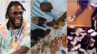 Burna Boy at 30: Singer decorates dance floor with hard currencies as he parties with friends