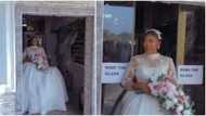 Scared big girl: Pretty bride screams in fear as automatic door holds back her flowing wedding dress in video
