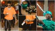 Plenty money: Wizkid shares photo showing bundles of naira & dollar notes at his feet, causes stir online