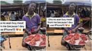 "E dey scare me": Young meat seller holds "iPhone 15", says people don't approach his stall