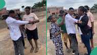 Young orphan rejoices as he signs out of Gregory University, Uturu, friends write on his shirt