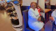 Robot serves food to a Nigerian lady, she speaks to it in Yoruba, funny video causes stir on social media