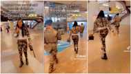 "Dem no even send her": Nigerian lady wears military camo colour abroad, dances beside soldiers in video