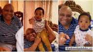 Davido’s uncle Senator Adeleke wears huge smile as he finally meets grandson for the first time