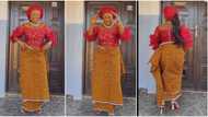"Whine waist": Lady in native wrapper dances for husband in front of house, sweet video goes viral on TikTok