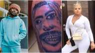 "Na Alake this one draw": Reactions as lady tattoos singer Asake's face on her leg, video causes stir online
