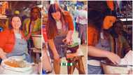 Oyinbo lady seen 'hustling' inside Nigerian market, video shows her grinding soup and selling Semo