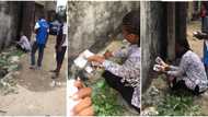 People Gather Around Nigerian Lady as She Sets Wads of n1K Notes on Fire in Viral Video, Says They Are Fake