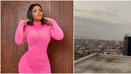 Actress Bimbo Ademoye screams for dear life as she climbs tall building with ladder on a movie set