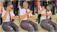 Pretty student in school uniform dances while sitting, loves sweet music playing, her video stirs reactions