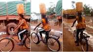 "Nothing is impossible": Woman carries yellow jerrycan on her head and rides bicycle with it, video emerges