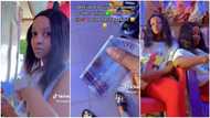 "Go and buy me recharge card": Lady uses seniority power over twin sister in video, gives her N1000 note