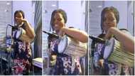 Yoruba talking drum makes beautiful noise, talented girl taps it with skillful hand, cute video causes stir