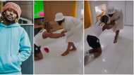 Asake screams in video as Woli Arole gives him hot 'spiritual slaps', makes him kneel for special prayers