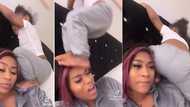 "These children dey worry": Mum in pain as little daughter uses her shoulder, head, as stepping stool in funny video