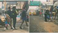 "She's a good mother": Nigerians celebrate policewoman who dresses school kids on the road, photos emerge