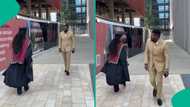 Nigerian lady in graduation gown and husband in suit nail the gwo gwo ngwo challenge