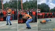 Male teacher in jeans wows students with lit moves & twists as he dances in schoolyard, they scream in video