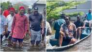 Viral photos show former President Jonathan riding in a canoe as he visits flood victims in Bayelsa