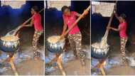 "I will be rich till I die": Slim lady in army camo turns plenty fufu for sale in large pot, video goes viral