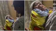 "He's not impressed": Video shows a 9-day-old baby with hand on cheek looking weirdly as woman sings for him