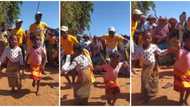 Little girl in wrapper gives lovely leg moves, dances barefooted on street, leaves adults screaming in video