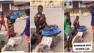 Emotional video shows young Nigerian hawker kneel on the road as he says prayers, people watch him