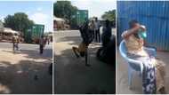 Woman in wrapper causes stir on street, front flips on one hand from the road to her seat, video wows people
