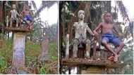 Nigerians react to photo of a young boy sitting beside a deity in a shrine, many say he is a spirit