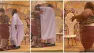 Plus-size bride in long dress shows cool hand moves as she dances on a spot with petite groom in cute video