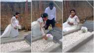 Bride visits father's grave in her white wedding gown, cries as she poses for photos