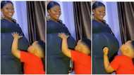Video as little boy holds his heavily pregnant mother, plays with her big baby bump in heartwarming way