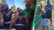 Davido mixes freely with fans, dances with little boy as he vacations abroad, videos melt hearts