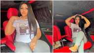 Elegant red interior, roof with shining starlight spotted as Regina Daniel poses inside her luxury car