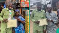 Son of plank seller honours parents as he completes NYSC, displays certificate