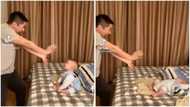 He understood the assignment: Baby falls on bed dramatically as he and dad 'fight' in funny video