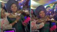 Drama as bride's sister slams female guest for spraying money on her sister's body during wedding
