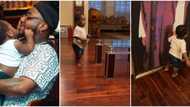 Heir apparent: Davido proudly shows off Ifeanyi as he plays and admires photos in his grandfather's mansion