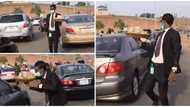 24-year-old Nigerian man who hawks kolanuts dressed in suit during traffic finally speaks, says he loves it