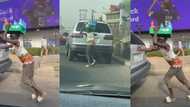 Reactions as Nigerian bottle water hawker helps push a car with one hand while balancing his goods on his head