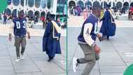 Man graduating from Birmingham University jumps on Brain Jotter's Gwo Gwo Ngwo at convocation