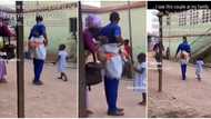 "Superb dad": Nigerian man and wife step out each backing their babies, she helps him on the road in video