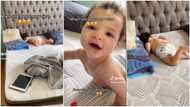 Baby in diaper hears her mum's voice, happily kicks legs, "pretends" to be sleeping in funny video