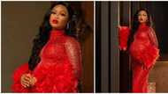 Pretty and pregnant: Expectant mum styles baby bump in jaw-dropping red look