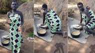 "Her skin is glowing": Pretty black mum bends down to use grinding stone with baby strapped to her back