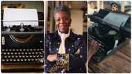 Nigerian woman uses old typewriter, runs her hands through it as words appear on the sheet