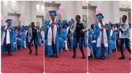 Little girl dances more than her graduating sister as she walks to the podium for her certificate