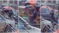 Policeman in uniform captured preaching in the rain on a busy road with speaker, video sparks reactions